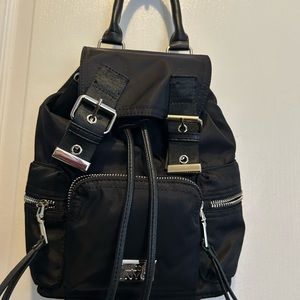 STEVE Madden Sleek Black Backpack with Durable Fabric and Drawstring Closure